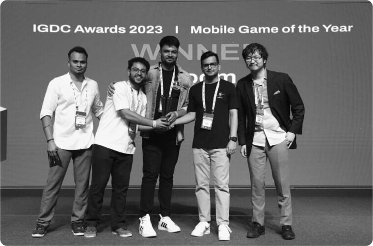Accepting the Mobile Game of the Year award on stage at the IGDC Awards